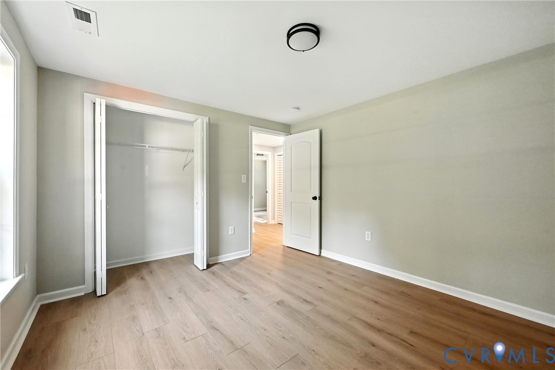 24611 Williamson Road Dinwiddie, VA 23841 - Photo 23 of 30 an empty room with wooden floor and windows