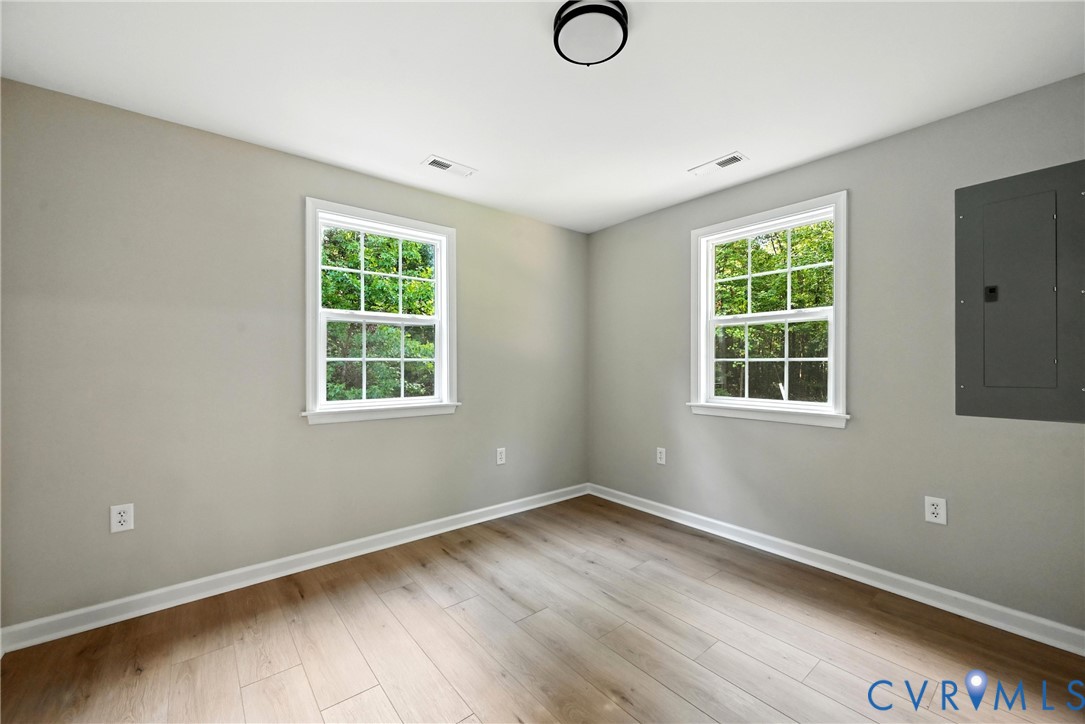 24611 Williamson Road Dinwiddie, VA 23841 - Photo 24 of 30 an empty room with wooden floor and windows