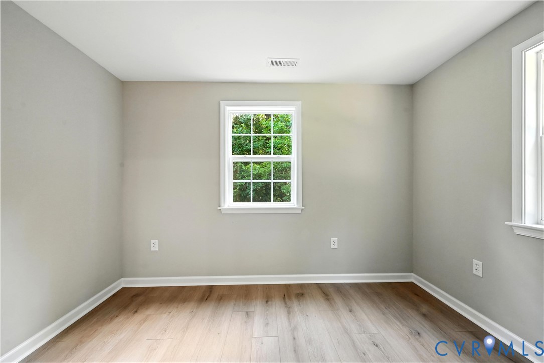 24611 Williamson Road Dinwiddie, VA 23841 - Photo 25 of 30 an empty room with wooden floor and windows
