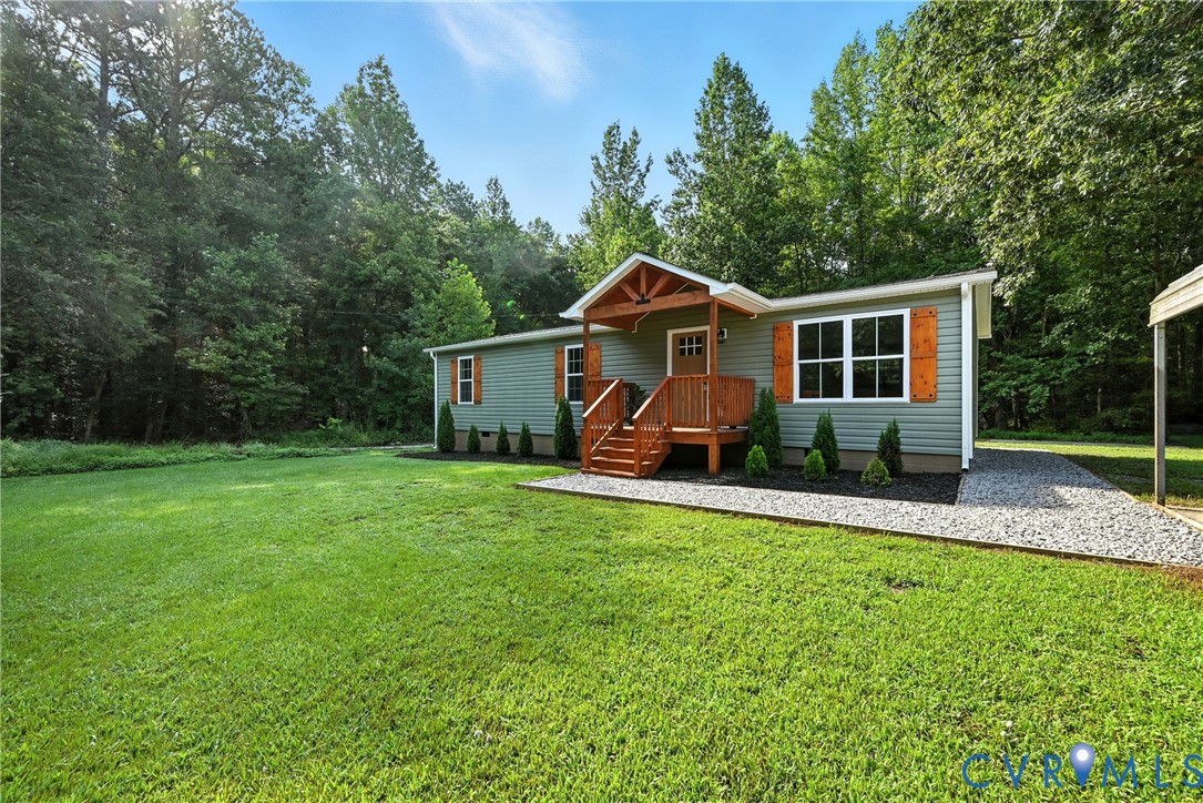 24611 Williamson Road Dinwiddie, VA 23841 - Photo 6 of 30 a front view of a house with a yard and trees