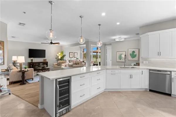 a living room with kitchen island furniture and a chandelier