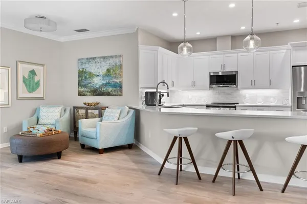 a kitchen with granite countertop white cabinets and stainless steel appliances