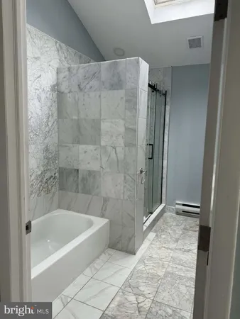 a bathroom with a bathtub and shower