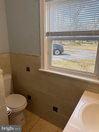 a bathroom with a toilet and a tub