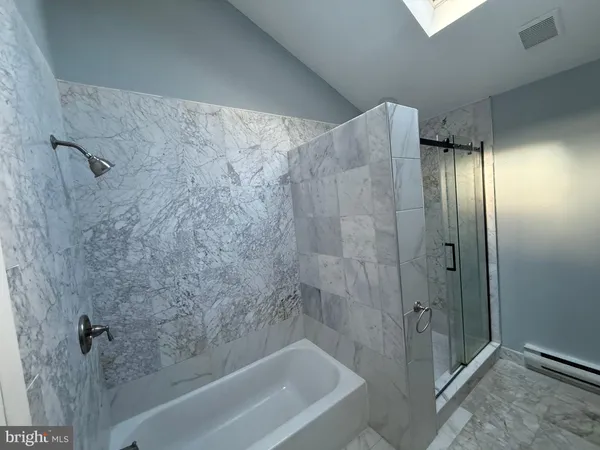 a bathroom with a bathtub and a shower
