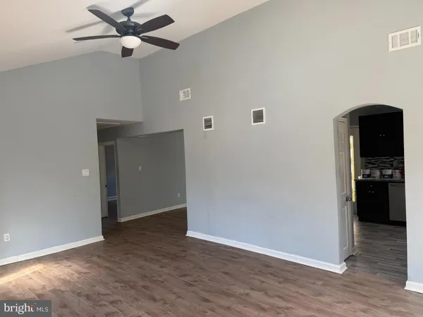 a view of a kitchen with a refrigerator and a ceiling fan