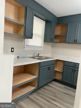 a kitchen with wooden cabinets and a sink