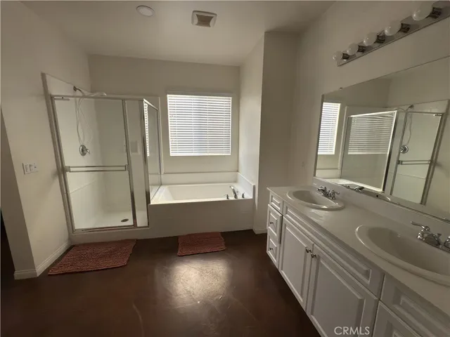 a bathroom with a double vanity sink and a mirror