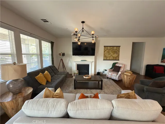 a living room with furniture fireplace and flat screen tv