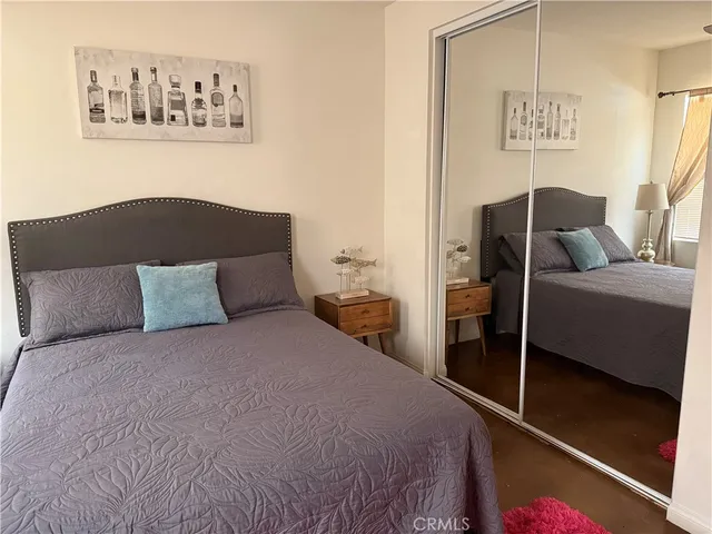 a bedroom with a bed and wall painting