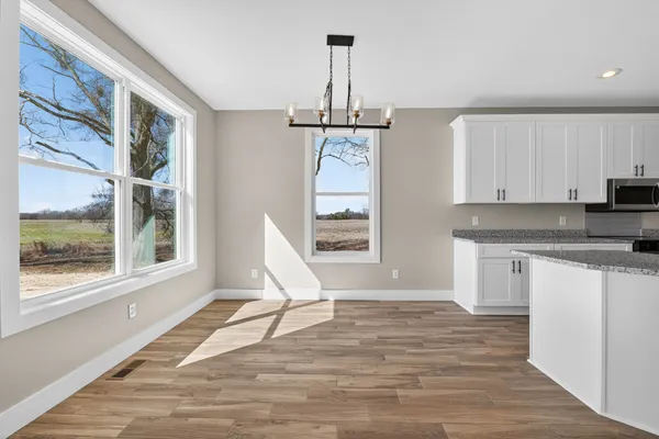 a view of a kitchen with a sink and dishwasher wooden floor