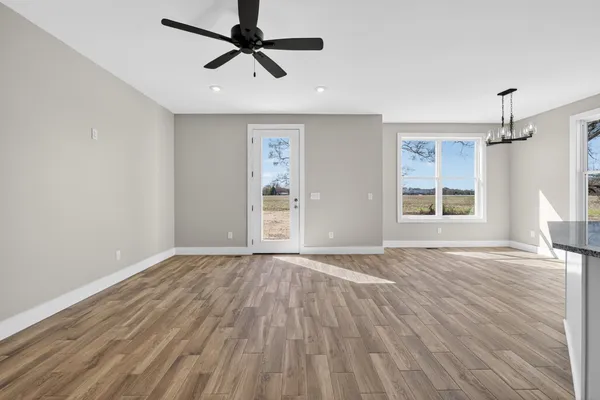 a view of a kitchen with wooden floor and a window
