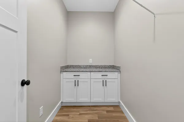 a bathroom with a granite countertop sink a toilet and shower