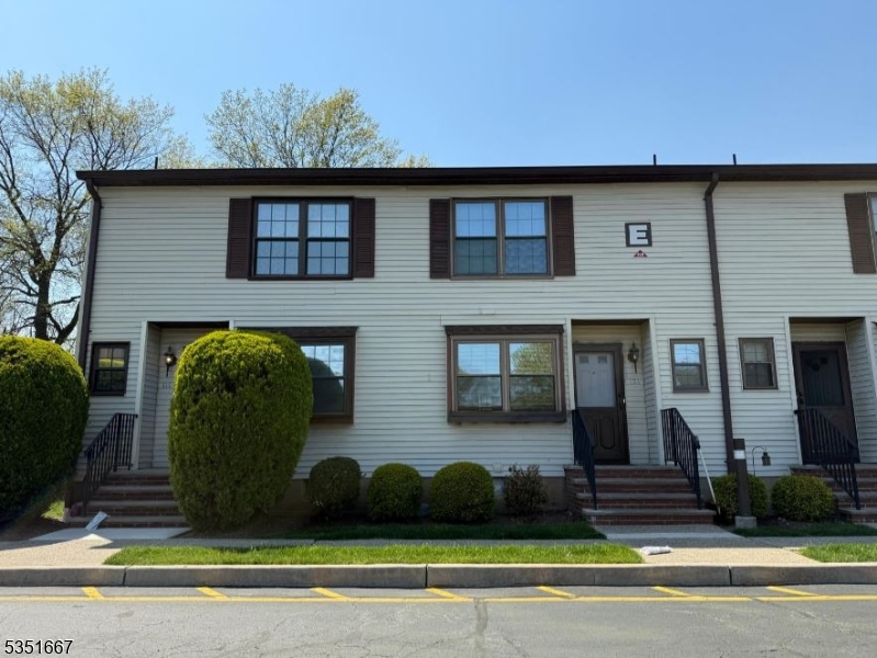 a front view of a house with garage and glass windows