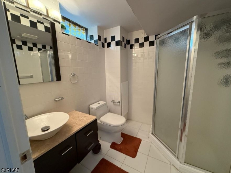 121 Dunham Avenue Edison, NJ 08817 - Photo 13 of 13 a bathroom with a sink a toilet a mirror and shower