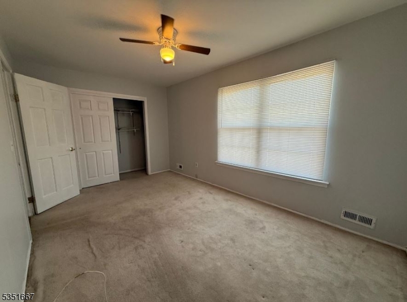 121 Dunham Avenue Edison, NJ 08817 - Photo 9 of 13 an empty room with a window and a fan