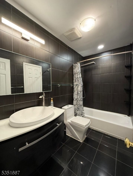 121 Dunham Avenue Edison, NJ 08817 - Photo 10 of 13 a bathroom with a sink a toilet a mirror and shower