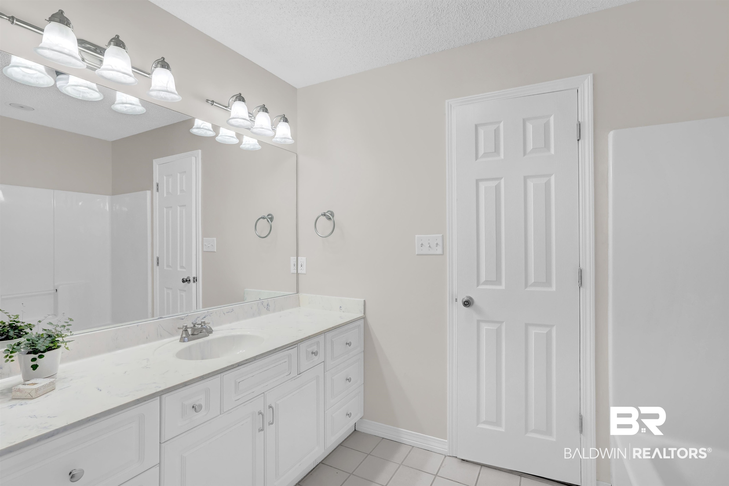 19741 Hunters Loop Fairhope, AL 36532 - Photo 26 of 42 Full bath featuring tile patterned floors, vanity, baseboards, and a textured ceiling