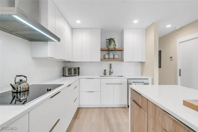 a kitchen with a sink cabinets and appliances
