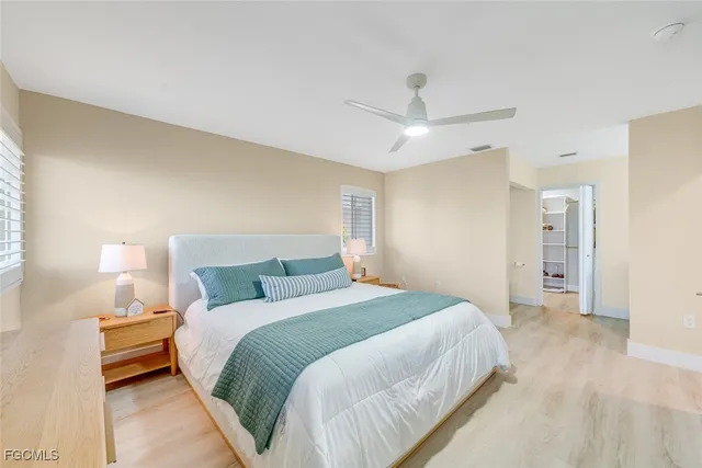 a bedroom with a bed and a lamp