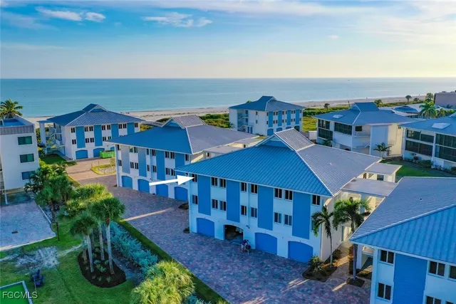 an aerial view of a house with swimming pool and furniture