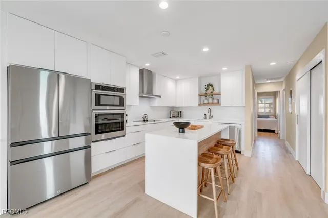 a kitchen with stainless steel appliances a refrigerator and a stove top oven