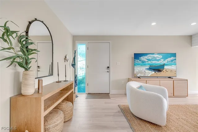 a living room with furniture a couch and a potted plant