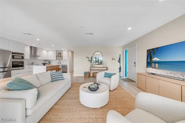 a living room with furniture kitchen view and a fireplace