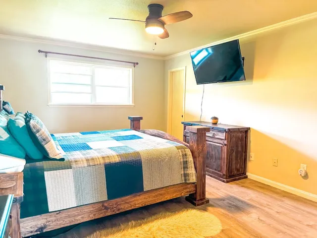 a bedroom with a bed and flat screen tv