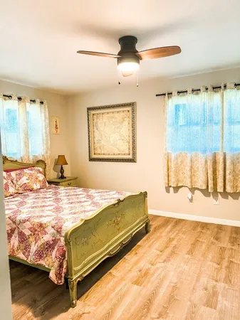 a bedroom with a bed and a large window