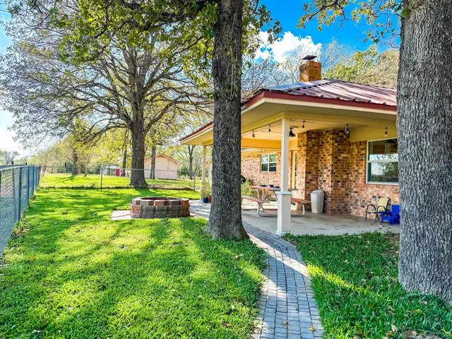 a view of a house with backyard porch and sitting area