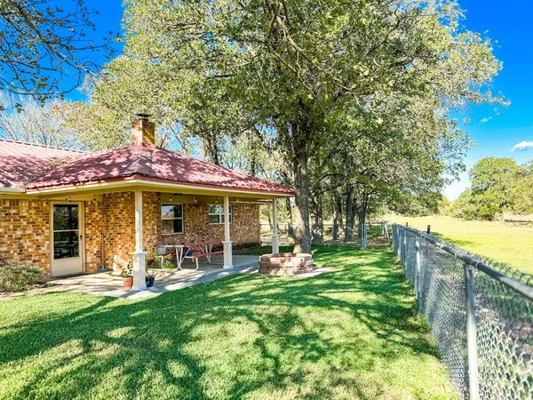 a view of a house with a yard porch and sitting area