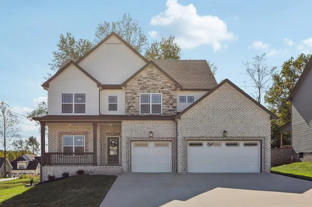 a view of house with garden and entertaining space