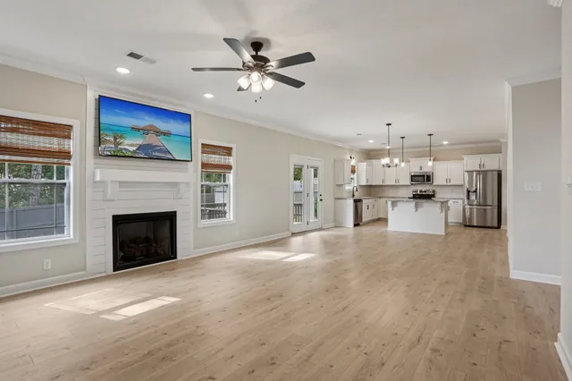 a view of a kitchen with refrigerator and window