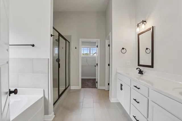 a bathroom with a double vanity sink a toilet and a mirror