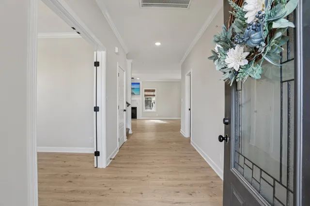 a view of an entryway with wooden floor