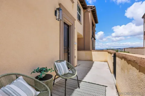 a balcony with furniture and a potted plant