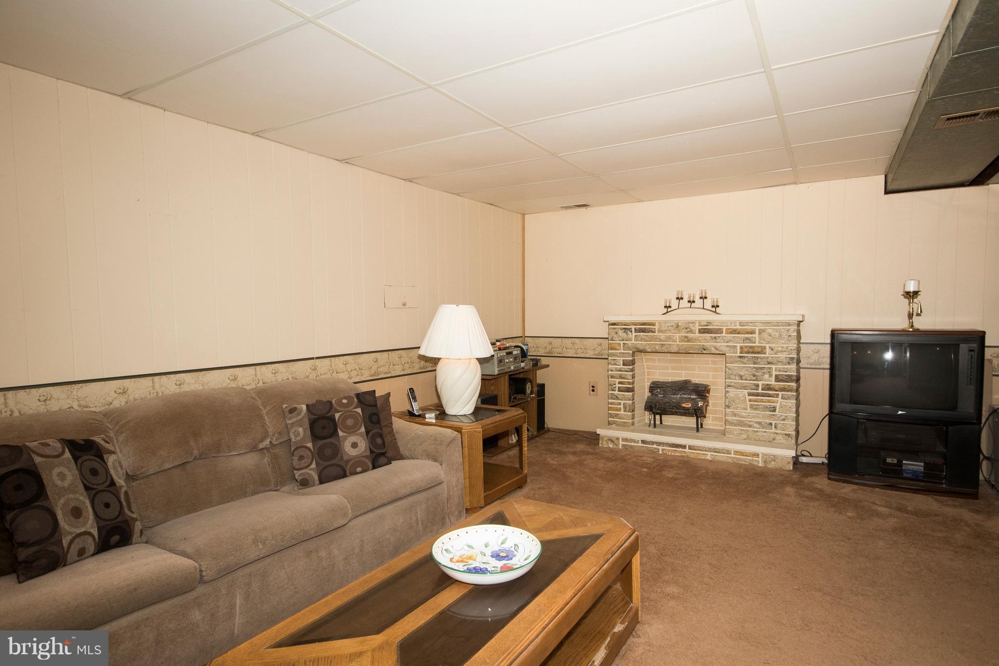 228 Embleton Road Owings Mills, MD 21117 - Photo 19 of 24 a living room with furniture and a fireplace