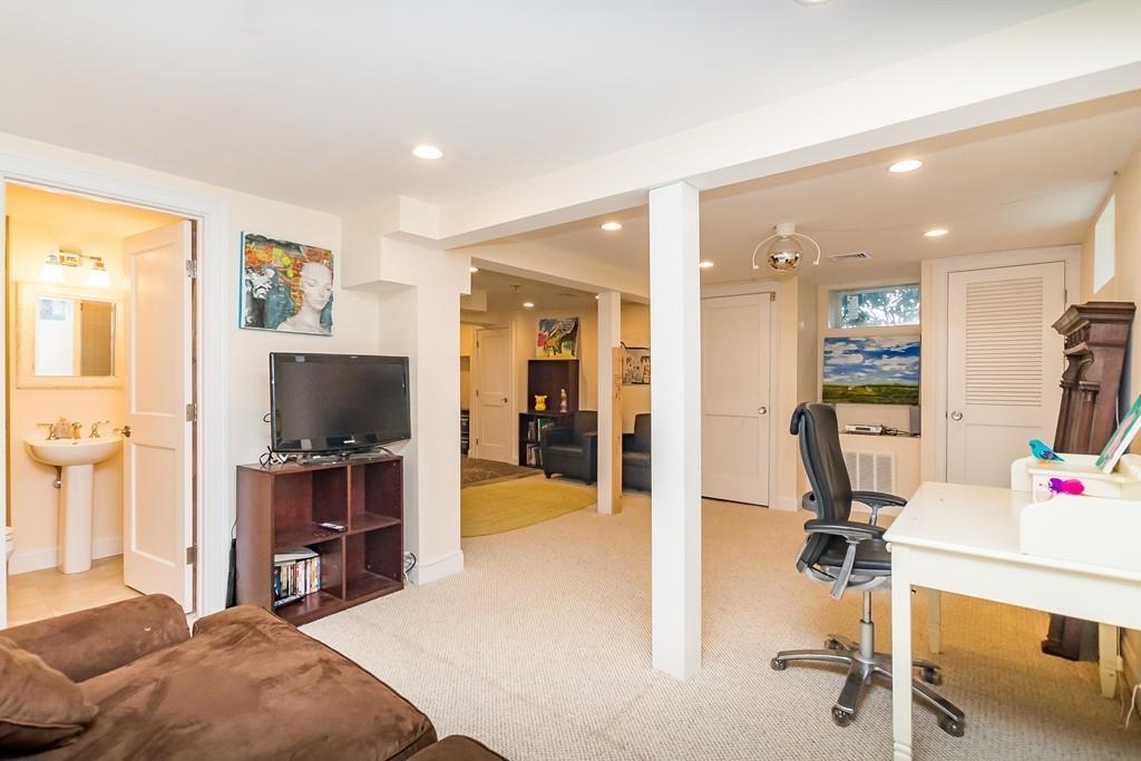 12 Vineyard Road Newton, MA 02459 - Photo 22 of 26 a living room with furniture and a flat screen tv