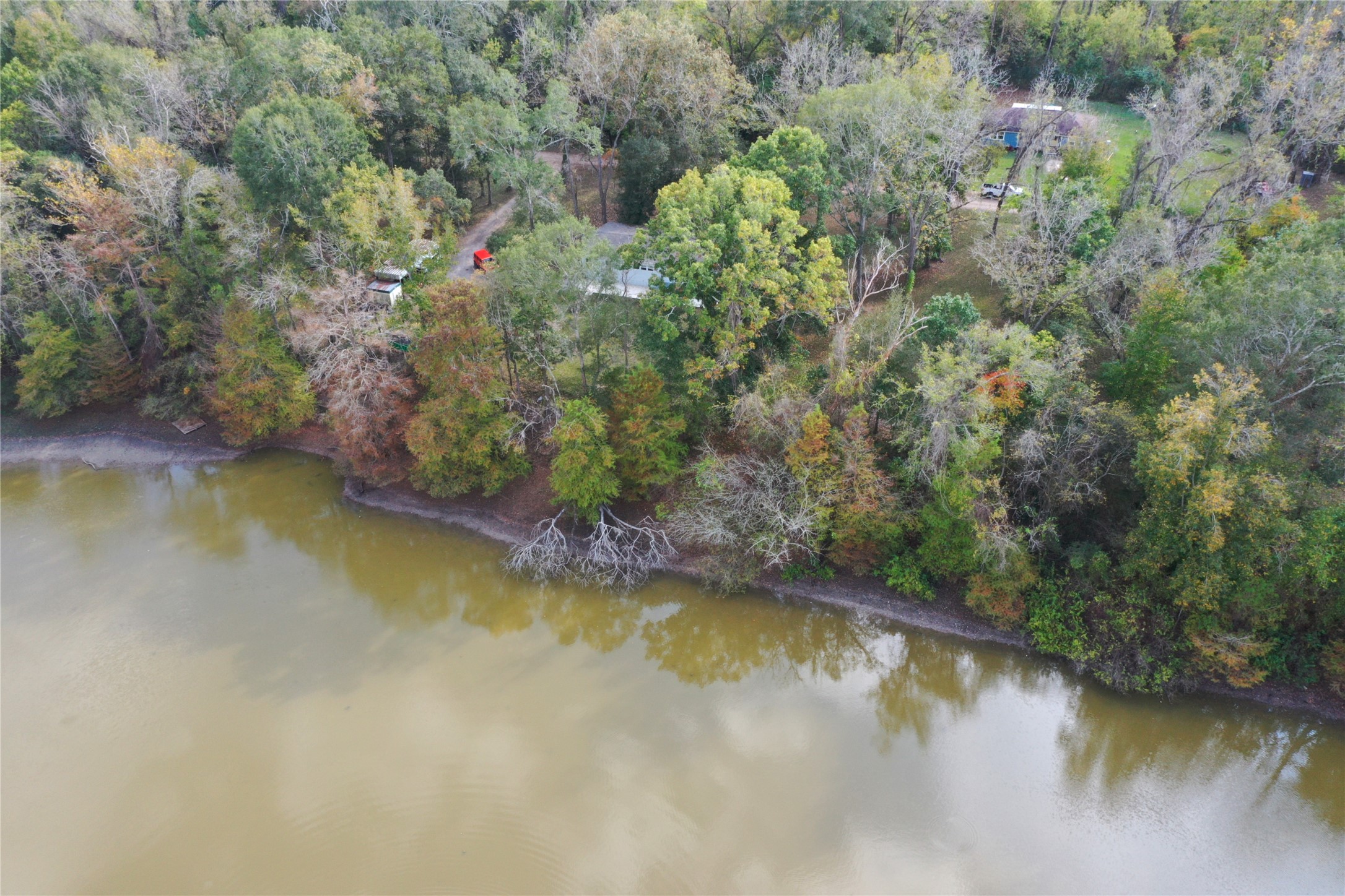 a view of a lake with trees all around