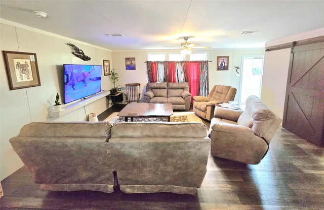 a living room with furniture and a flat screen tv