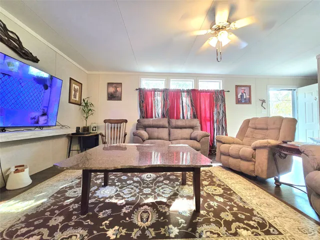 a living room with furniture and wooden floor