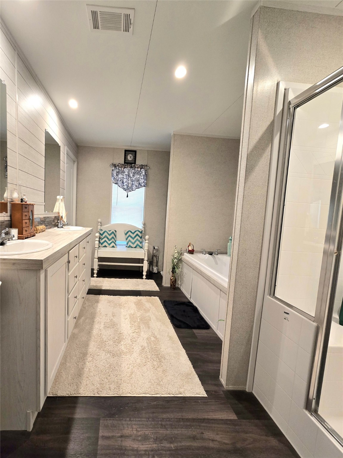 223 County Road 2167B Cleveland, TX 77327 - Photo 22 of 50 a bathroom with a tub sink vanity and a mirror