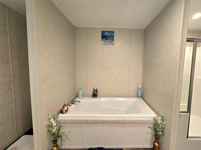 a bedroom with a bed a fireplace and windows