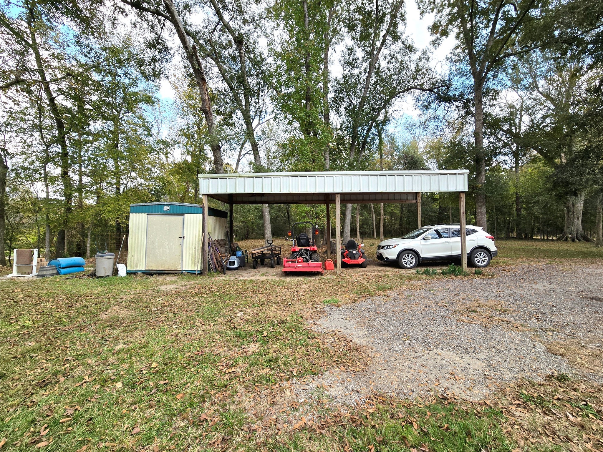223 County Road 2167B Cleveland, TX 77327 - Photo 33 of 50 a view of a house with a yard and car parked