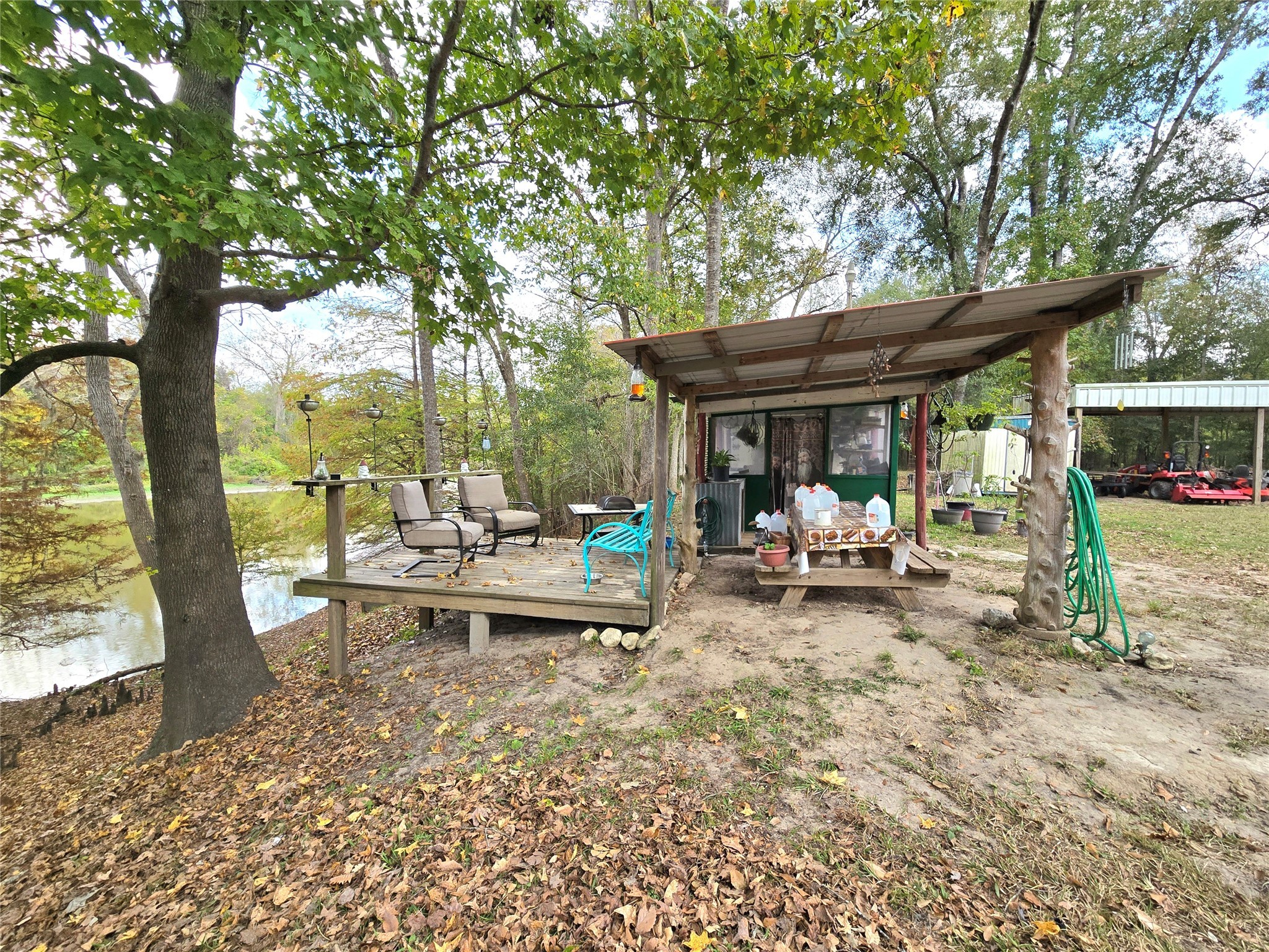 223 County Road 2167B Cleveland, TX 77327 - Photo 35 of 50 a view of a patio with table and chairs under an umbrella