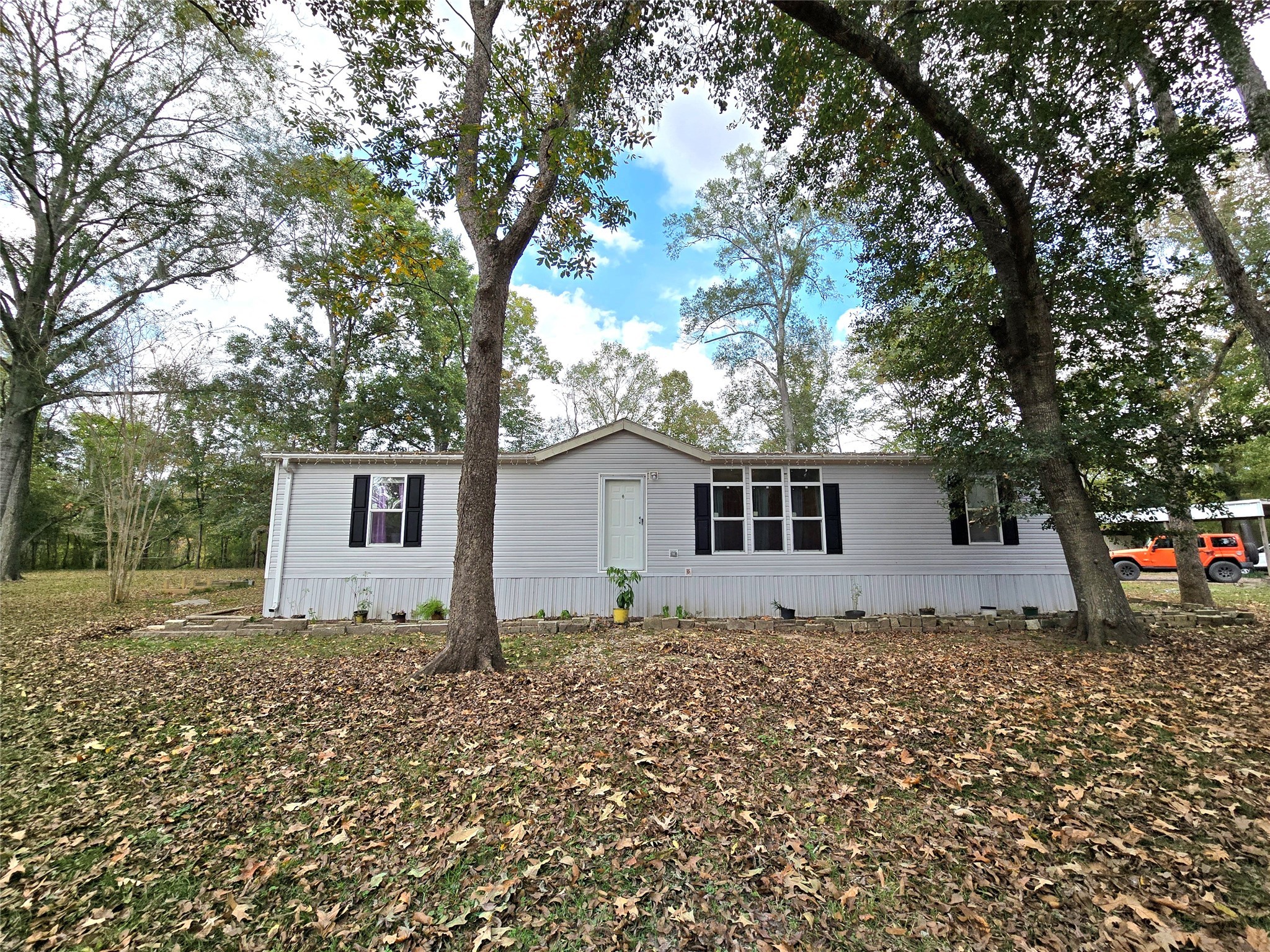 223 County Road 2167B Cleveland, TX 77327 - Photo 7 of 50 a house that has a tree in front of it