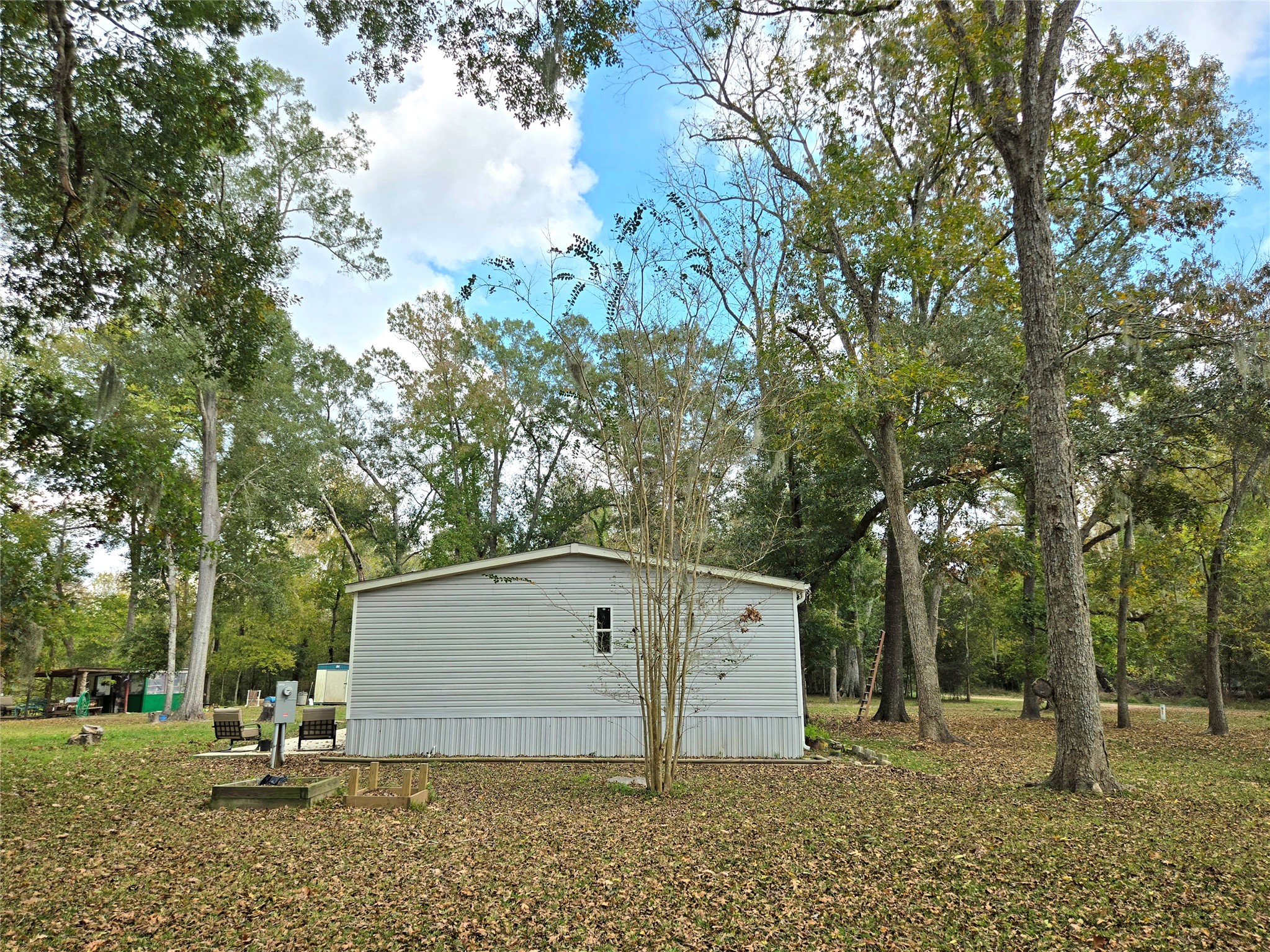 223 County Road 2167B Cleveland, TX 77327 - Photo 9 of 50 a view of a house with a yard