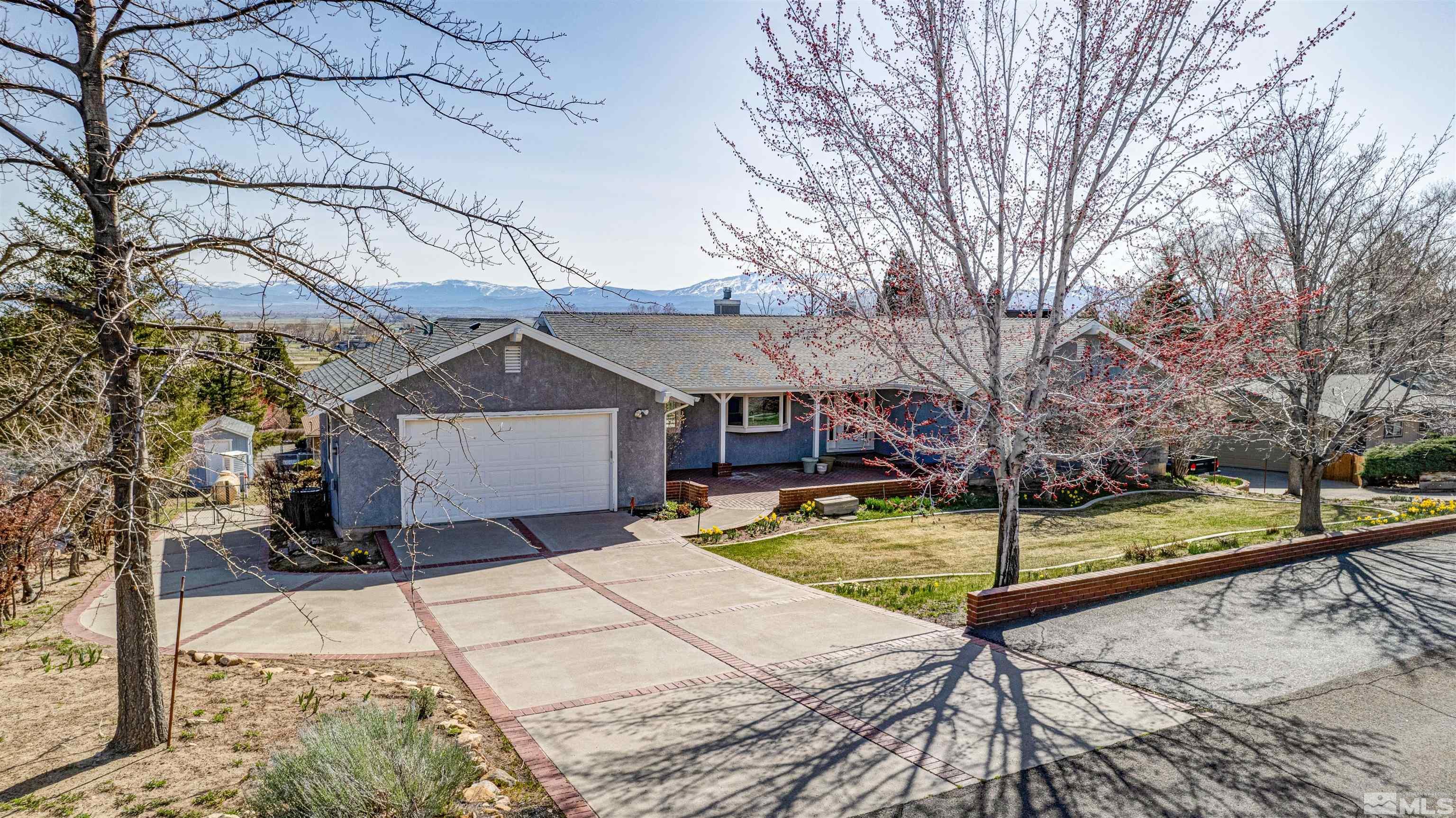 a view of a house with snow on the road