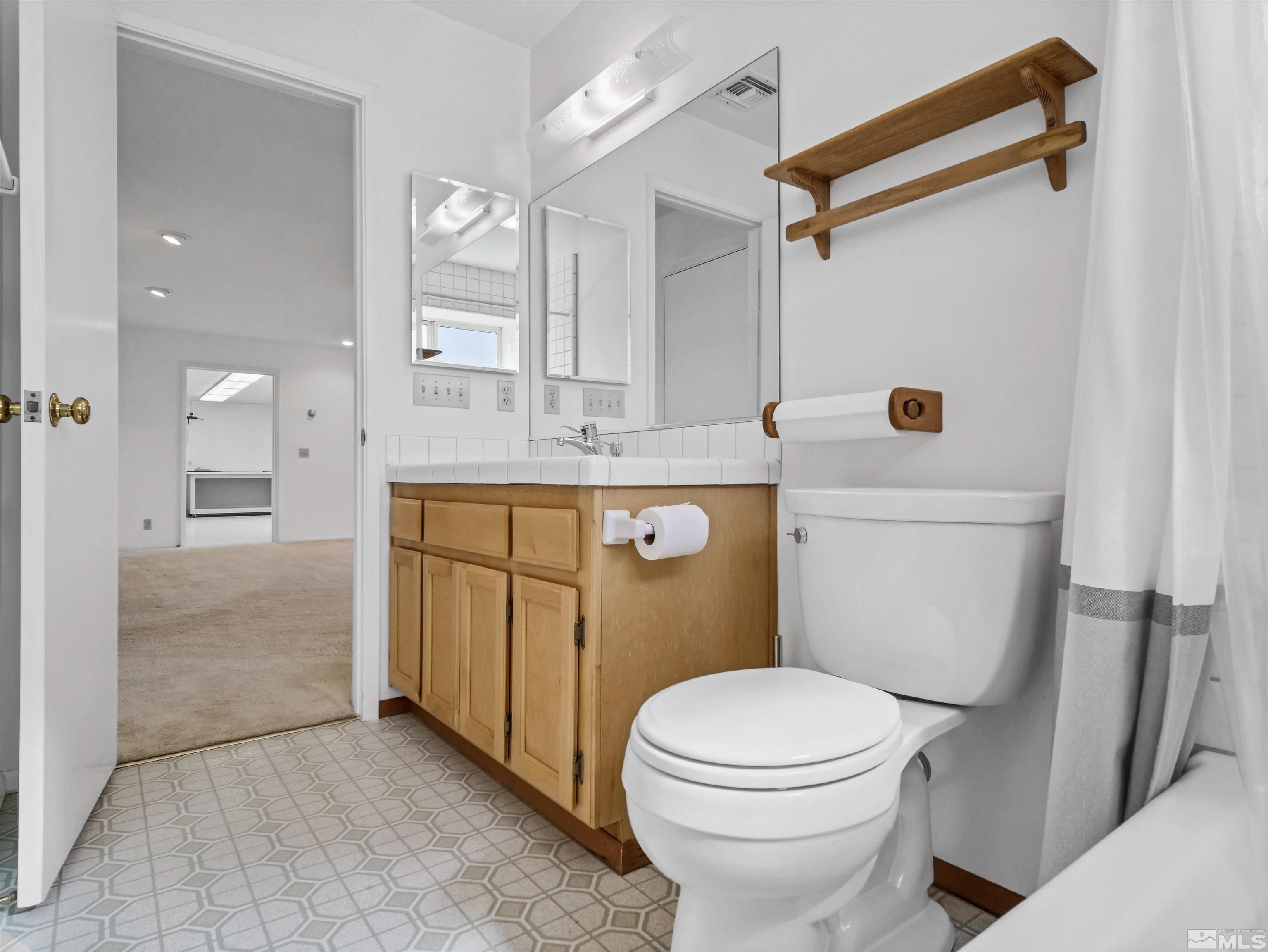 875 Bollen Circle Gardnerville, NV 89460 - Photo 20 of 26 a bathroom with a sink a toilet and shower